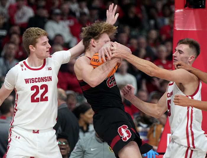 Tyler Wahl tries to pry the ball away from the Stanford offensive player